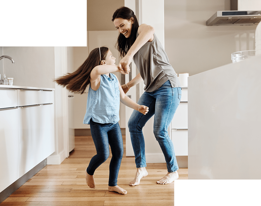 mother and daughter playing in the kitchen