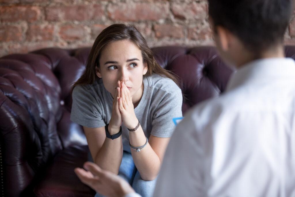 Unhappy young girl at the psychologist